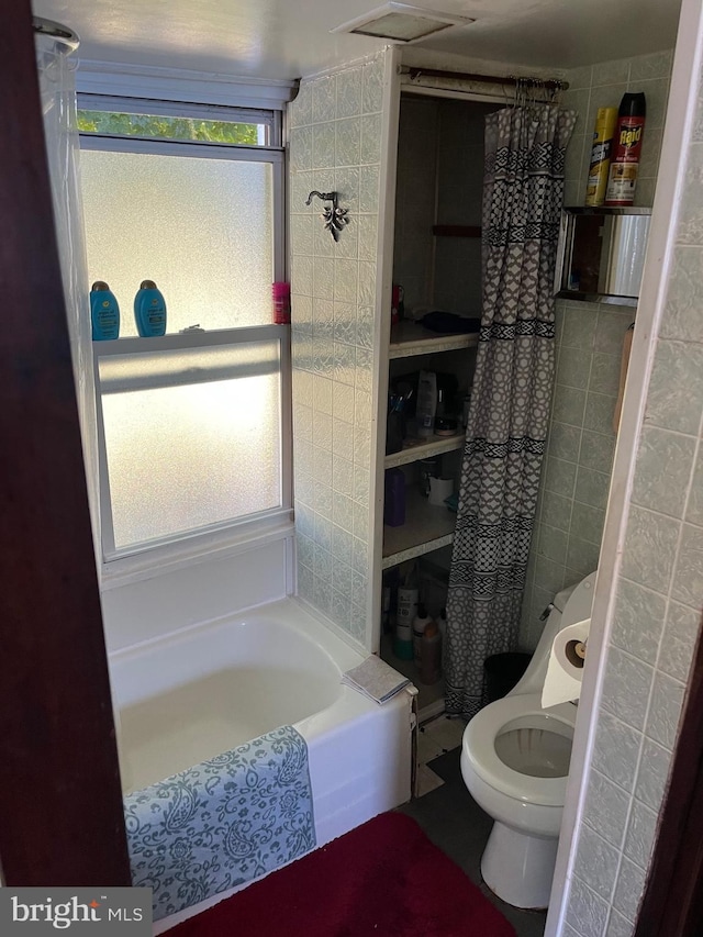 bathroom with shower / bath combo and toilet