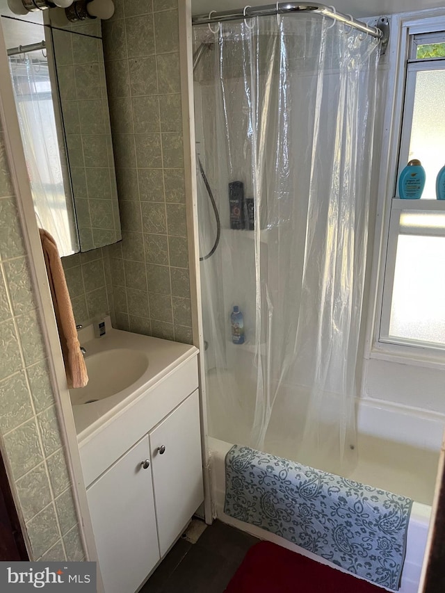 bathroom with vanity and shower / tub combo with curtain