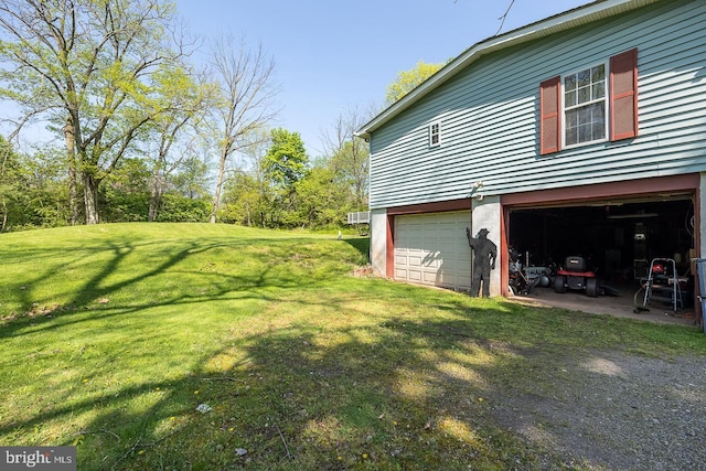 view of side of home with a garage and a yard