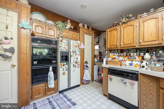 kitchen featuring white appliances and a textured ceiling