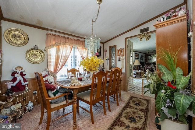 dining space with carpet, ornamental molding, a textured ceiling, a chandelier, and lofted ceiling