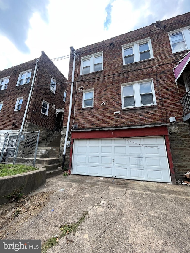 rear view of house with a garage