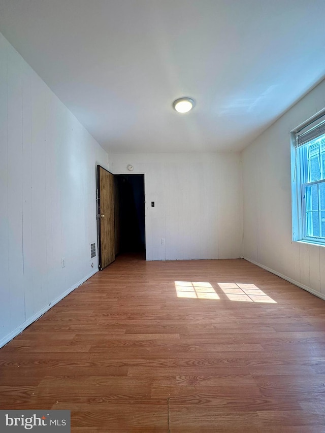 spare room with light hardwood / wood-style flooring