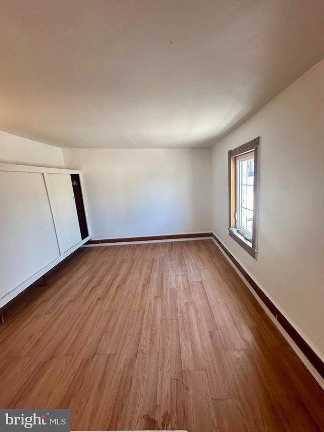 unfurnished room featuring hardwood / wood-style flooring