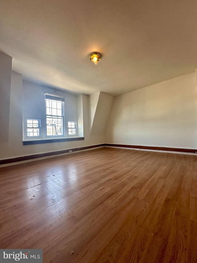 spare room with hardwood / wood-style flooring