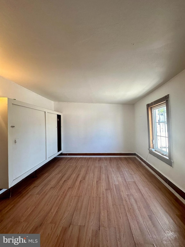 unfurnished bedroom with hardwood / wood-style flooring