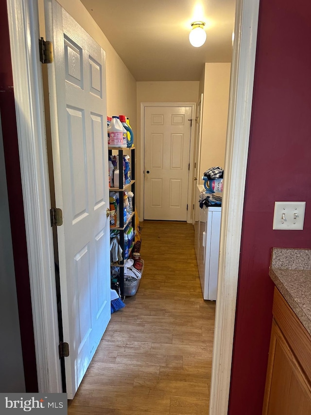 corridor with light hardwood / wood-style flooring