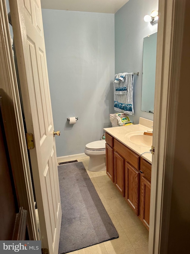 bathroom featuring toilet and vanity