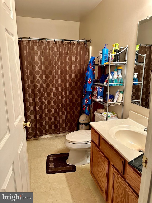 bathroom with toilet, vanity, and a shower with curtain