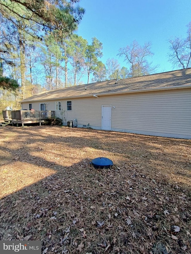 rear view of house with a wooden deck