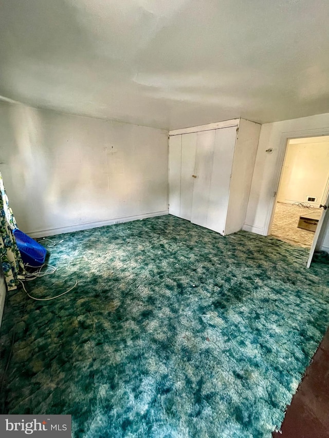 unfurnished bedroom with dark carpet