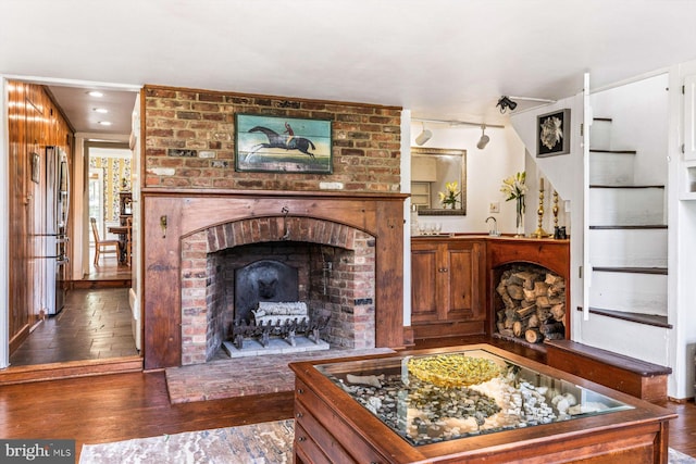 living room with hardwood / wood-style floors and a fireplace