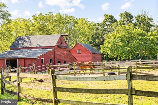 view of horse barn with a rural view