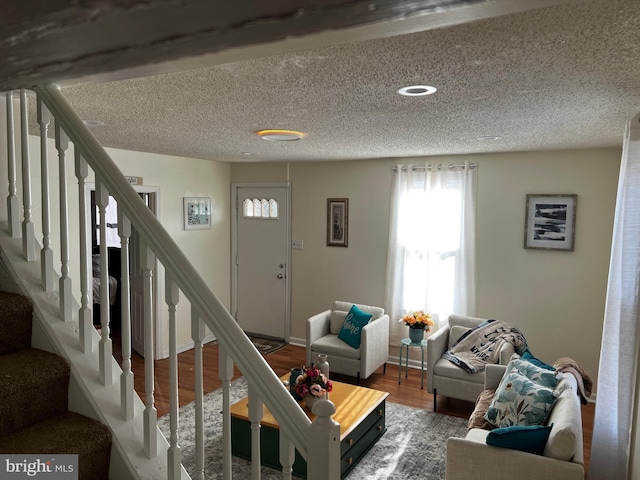 living room with hardwood / wood-style flooring and a textured ceiling