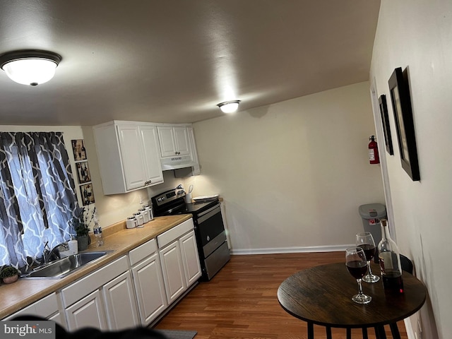 kitchen featuring white cabinets, black electric range oven, sink, and dark wood-type flooring