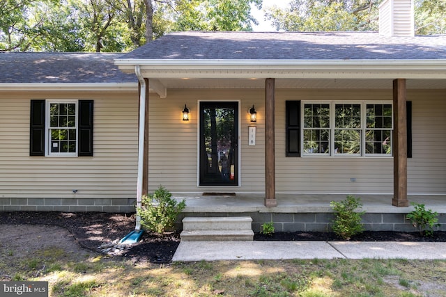 view of exterior entry featuring a porch