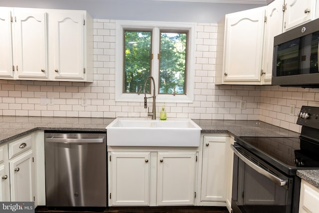 kitchen featuring white cabinets, backsplash, stainless steel appliances, and sink