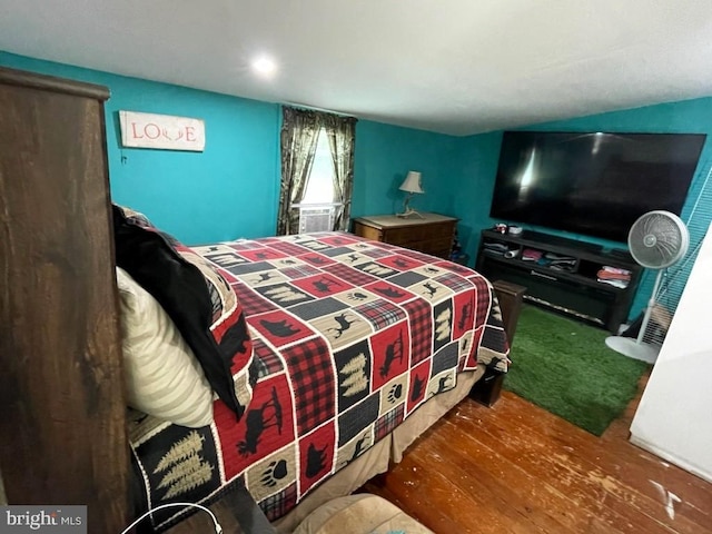 bedroom with hardwood / wood-style floors and cooling unit