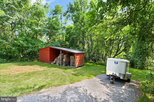 view of outbuilding featuring a yard