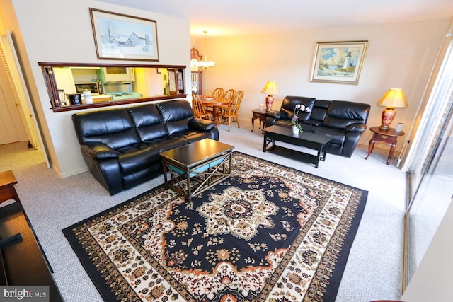 carpeted living room featuring a notable chandelier