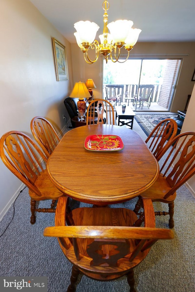 dining room with a chandelier and carpet