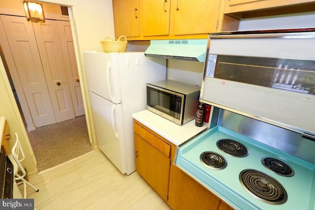 kitchen with ventilation hood, white fridge, and light colored carpet