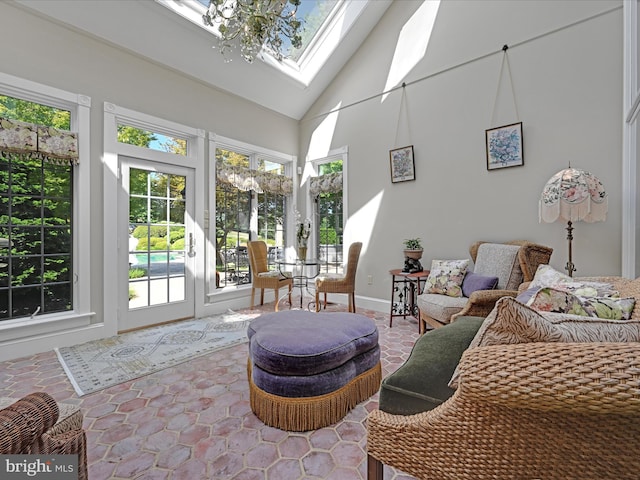 sunroom / solarium featuring vaulted ceiling with skylight