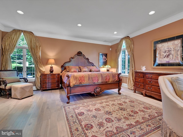 bedroom featuring light hardwood / wood-style flooring, multiple windows, and crown molding