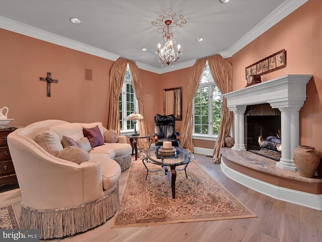 living room with crown molding, a high end fireplace, light hardwood / wood-style floors, and an inviting chandelier