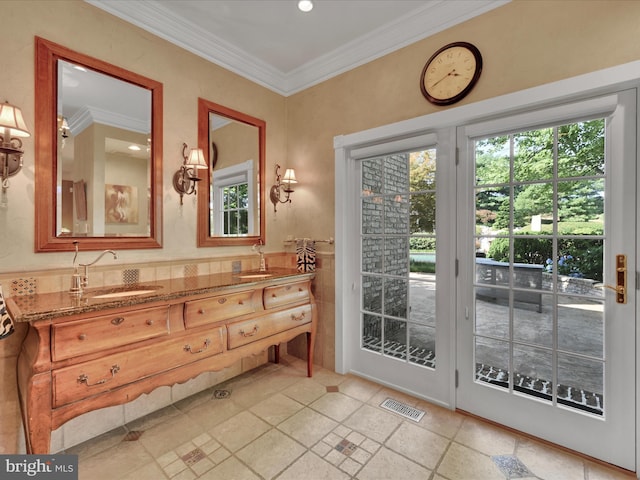 doorway featuring crown molding and sink