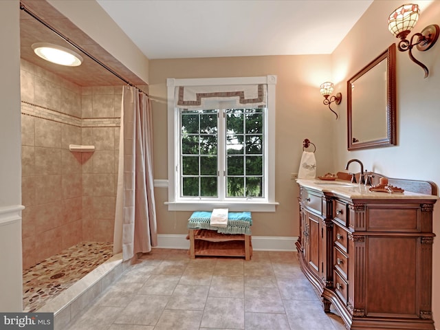 bathroom featuring tile patterned flooring, vanity, and walk in shower