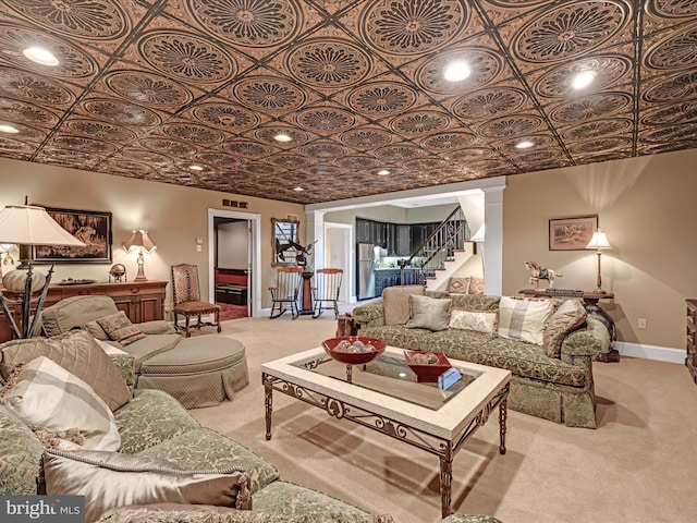 carpeted living room featuring ornate columns