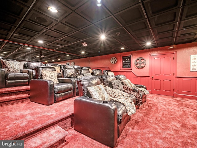 home theater room with carpet and coffered ceiling