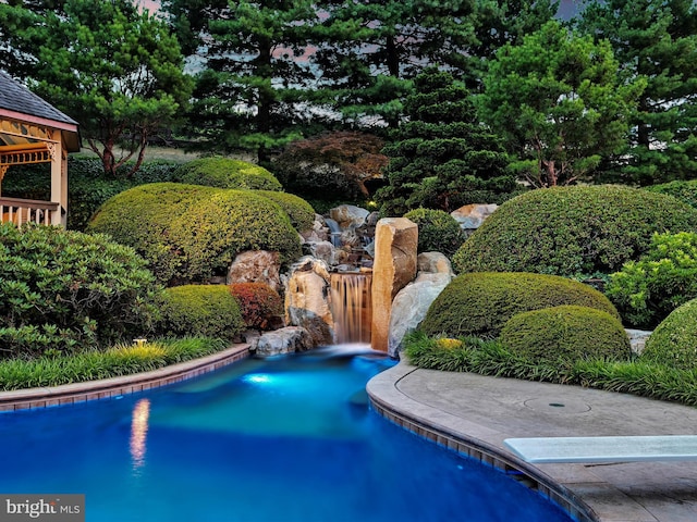 view of pool featuring a diving board