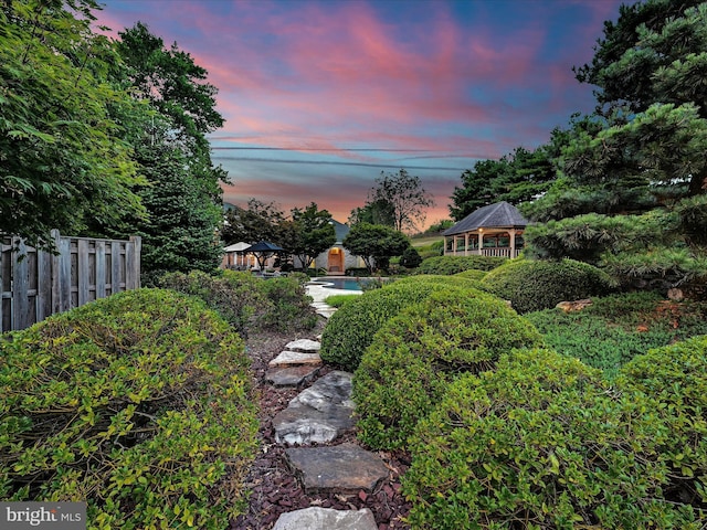 yard at dusk featuring a gazebo