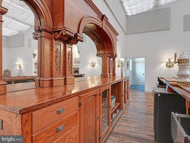 bar with light hardwood / wood-style floors