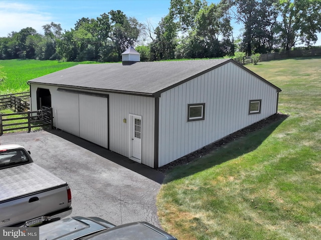 view of outbuilding featuring a yard