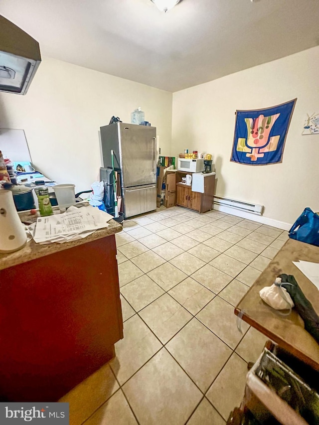 tiled office space featuring a baseboard heating unit