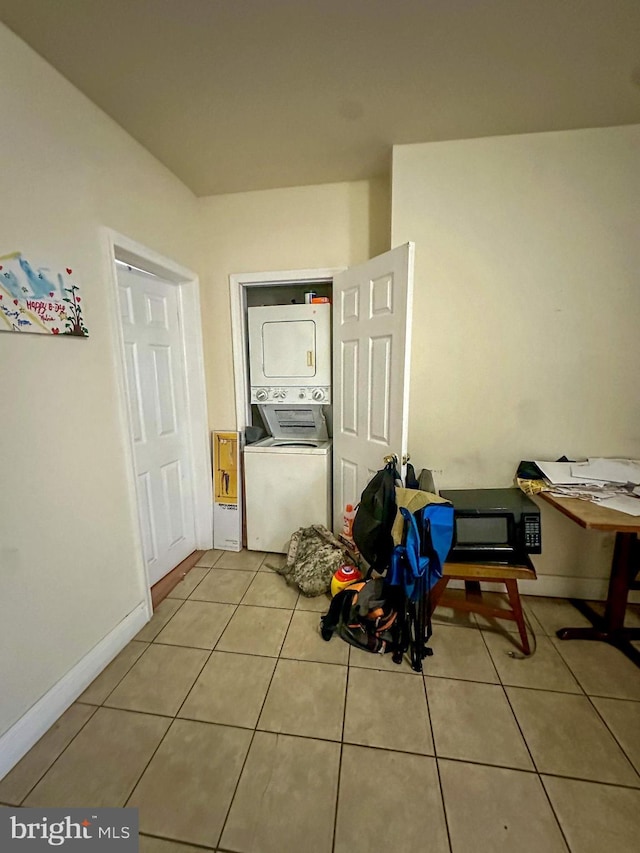 interior space featuring stacked washing maching and dryer