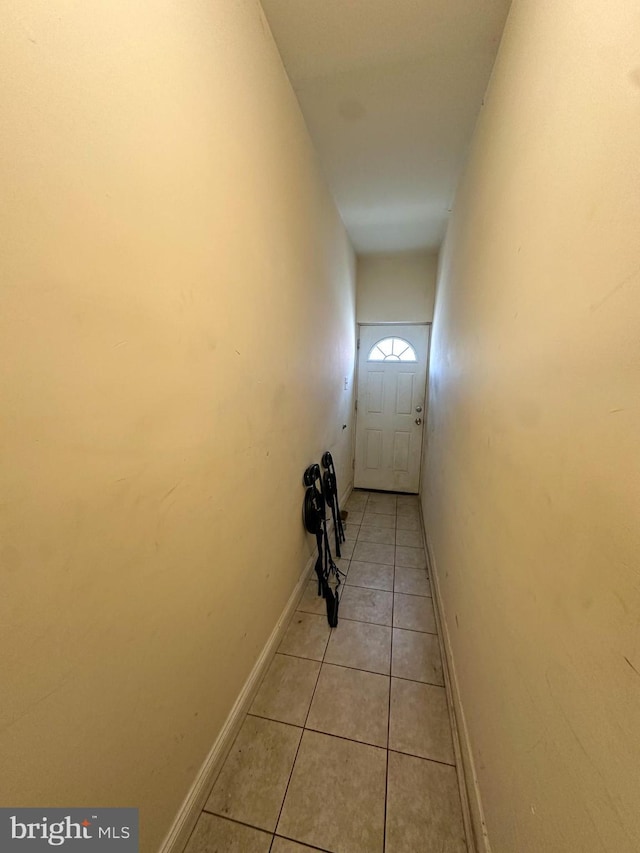 hall with light tile patterned floors