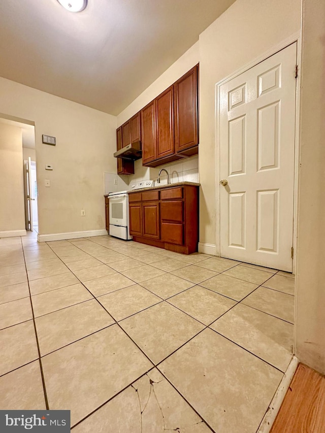 kitchen with white range with electric stovetop, sink, and light tile patterned floors