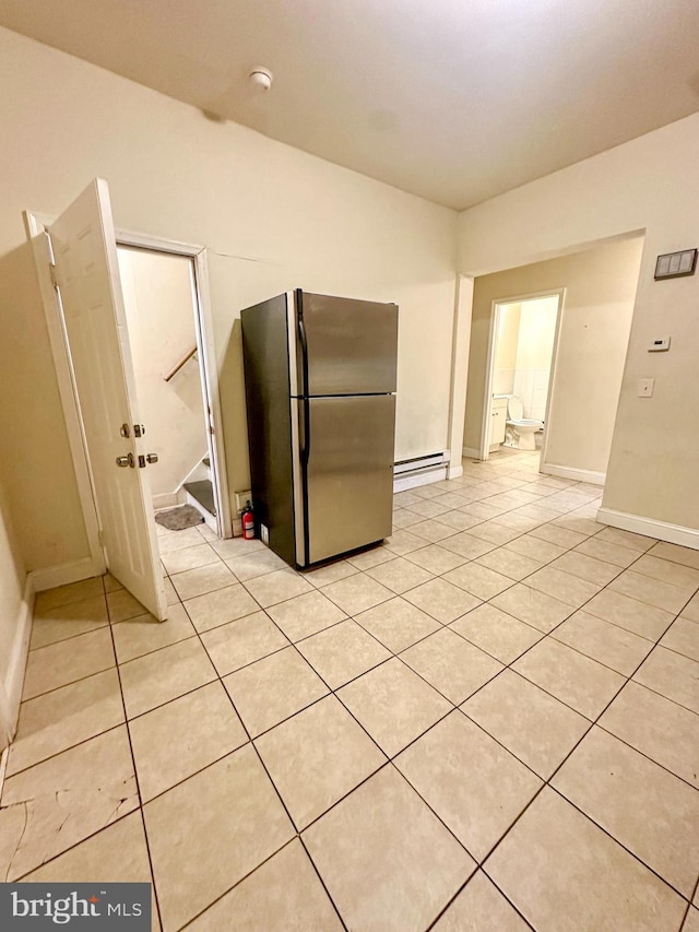 kitchen featuring stainless steel fridge and light tile patterned flooring