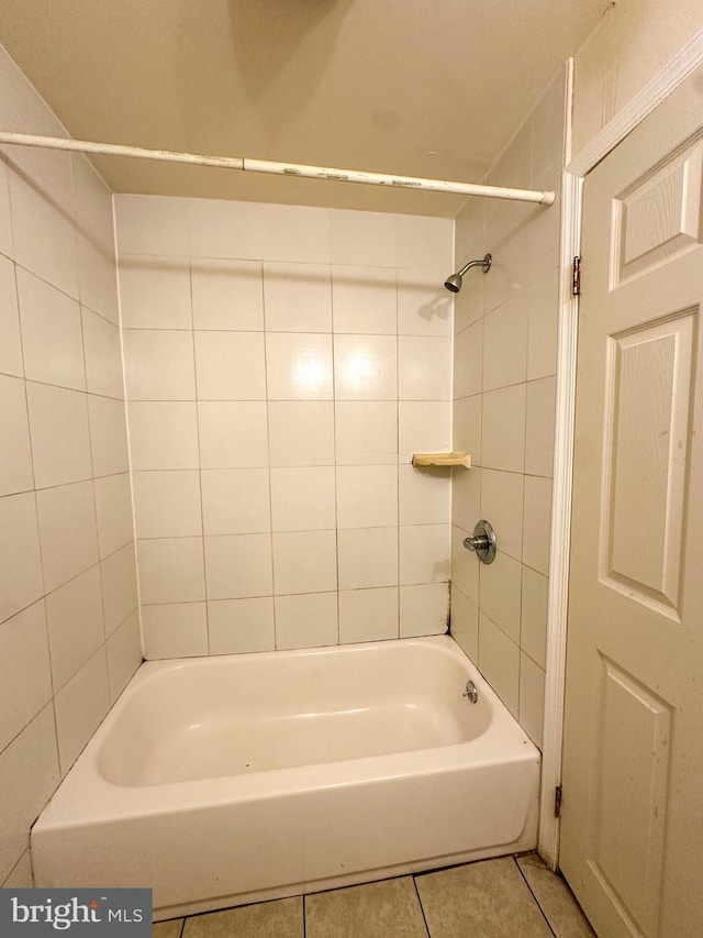 bathroom featuring tiled shower / bath combo and tile patterned floors