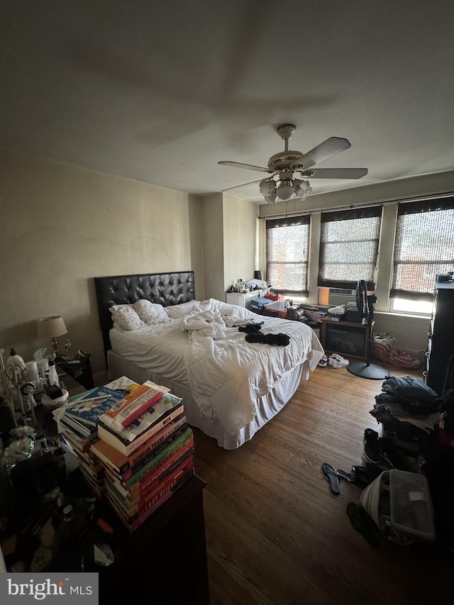 bedroom featuring hardwood / wood-style floors and ceiling fan