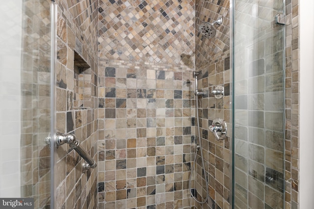 bathroom with a shower with door