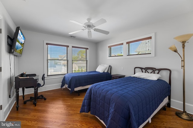 bedroom with dark wood-type flooring and ceiling fan