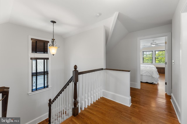 stairs featuring hardwood / wood-style flooring and lofted ceiling