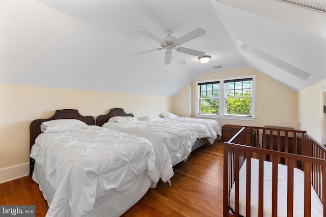 bedroom featuring dark wood-type flooring, ceiling fan, and vaulted ceiling