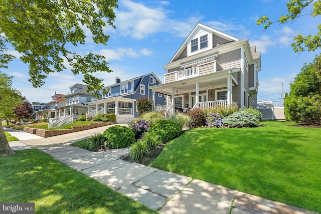 victorian home featuring covered porch and a front yard