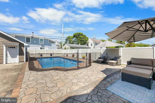 view of swimming pool with an outdoor living space and a patio area